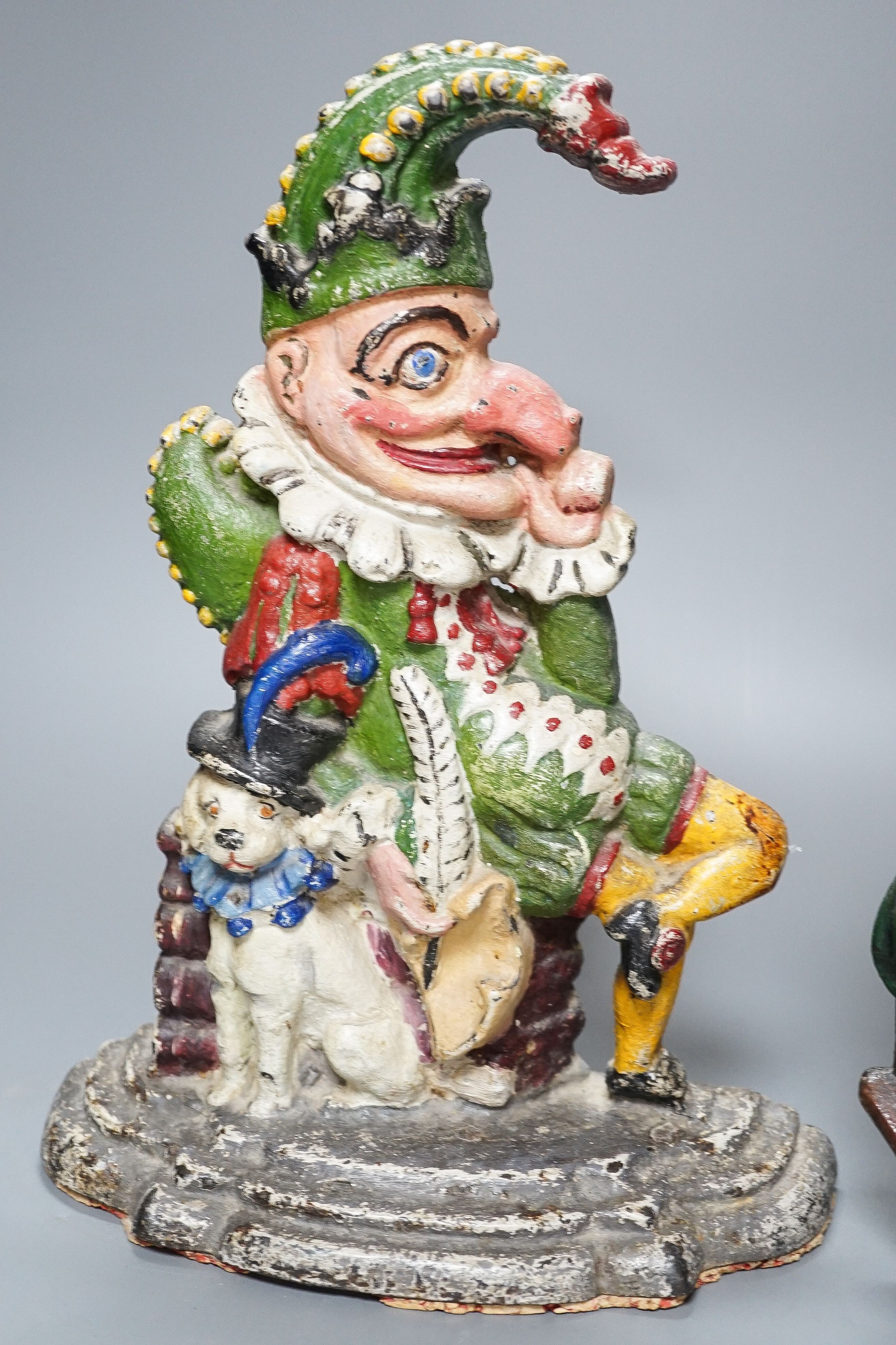 Three Victorian painted cast iron door stops (re-painted) 31cm and a later figure